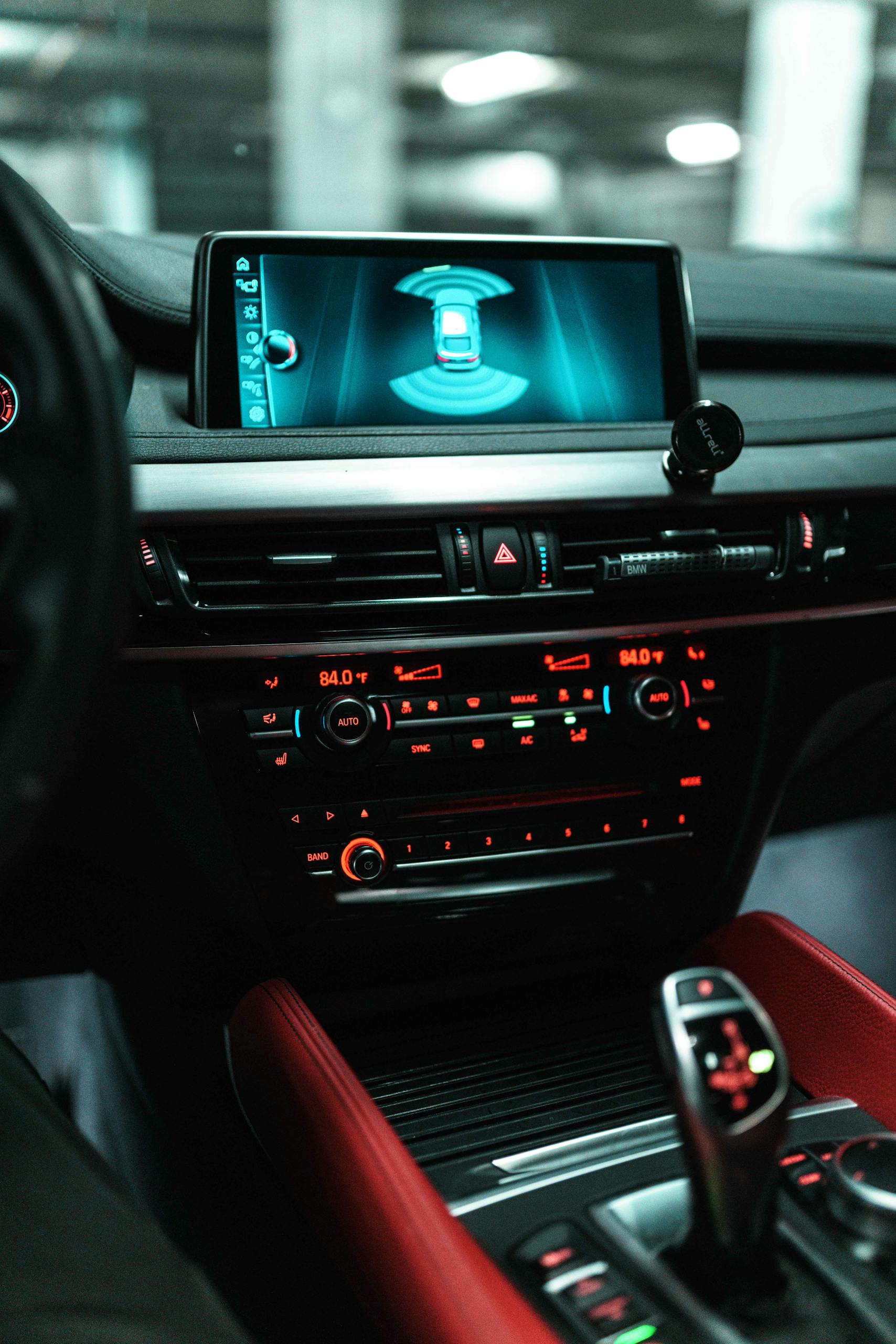 Close-up of a car dashboard with a digital screen and controls.